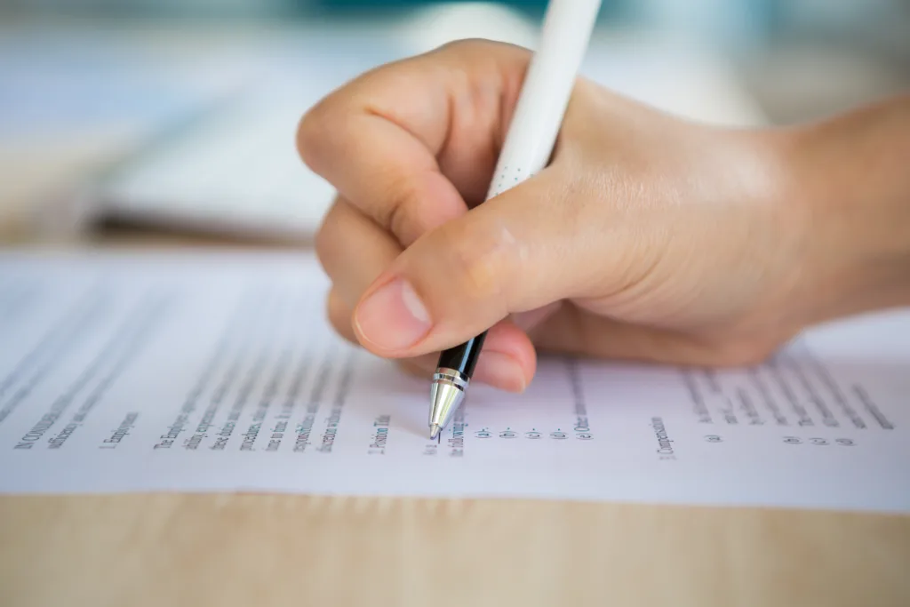 Hand with pen writing paper 1 1024x683.webp.webp