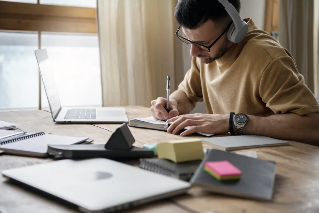 Young man writing notebook study session 2 1024x683.webp.webp